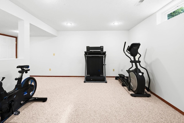 exercise room with carpet floors and baseboards