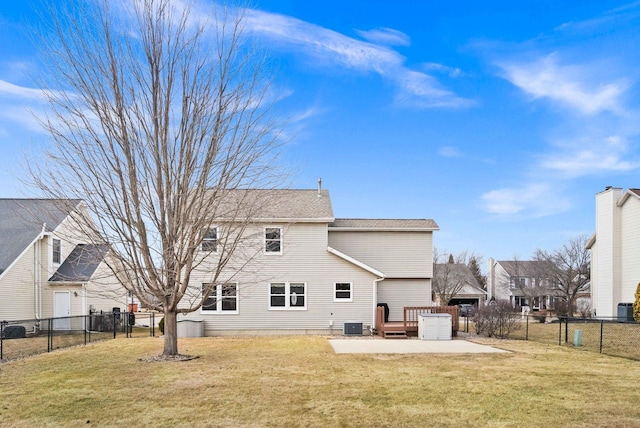 rear view of property with a yard, a patio, a garage, a fenced backyard, and driveway