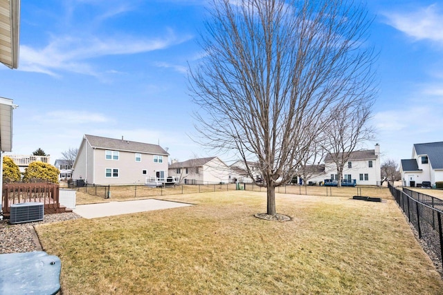 view of yard with a patio area, a fenced backyard, a residential view, and central air condition unit