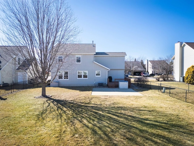 rear view of property with a patio area, a fenced backyard, and a lawn