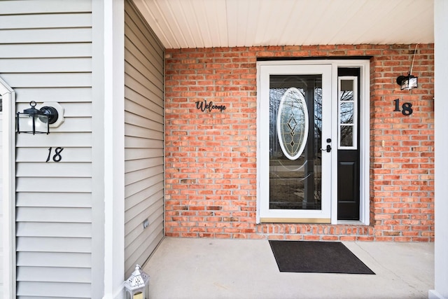 entrance to property with brick siding