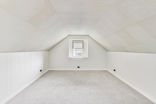 bonus room featuring carpet flooring, baseboards, and vaulted ceiling