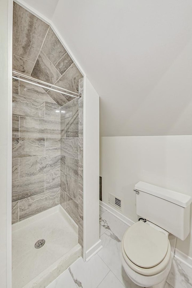 bathroom featuring vaulted ceiling, visible vents, marble finish floor, and a shower stall