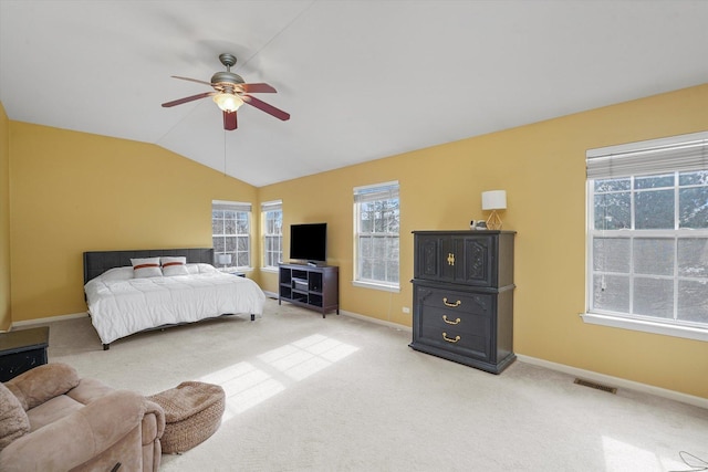 bedroom featuring visible vents, light carpet, vaulted ceiling, ceiling fan, and baseboards