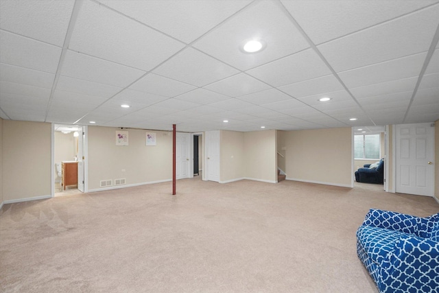 finished below grade area with baseboards, recessed lighting, and light colored carpet