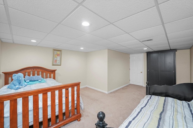 bedroom with carpet, baseboards, a drop ceiling, and recessed lighting