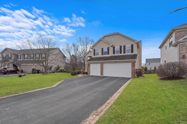 traditional-style home featuring aphalt driveway, a front yard, brick siding, and an attached garage