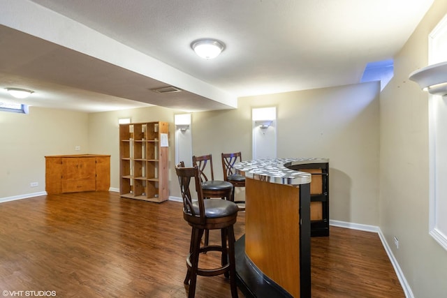 bar with baseboards and dark wood-type flooring