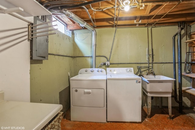 laundry room featuring laundry area, a sink, and separate washer and dryer