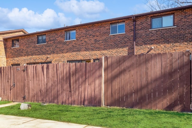 view of home's exterior featuring fence and brick siding