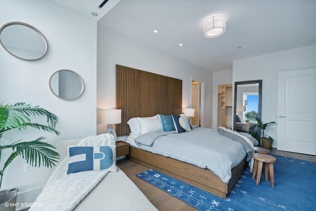 bedroom featuring wood finished floors and visible vents