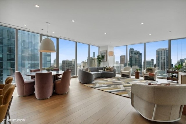 living area featuring expansive windows, wood finished floors, and a view of city