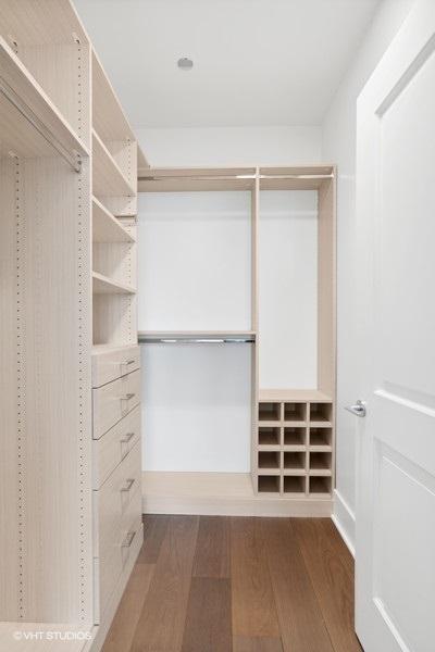 spacious closet with wood finished floors