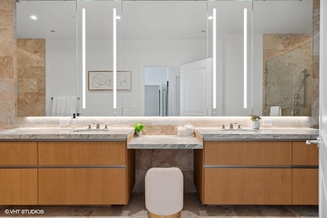 bathroom featuring a stall shower and vanity