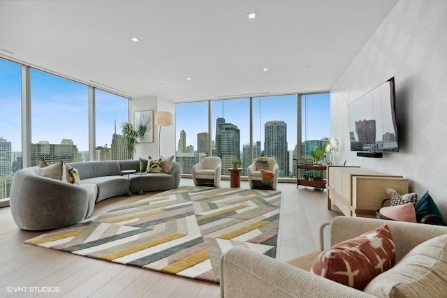 living room with a wall of windows and hardwood / wood-style floors