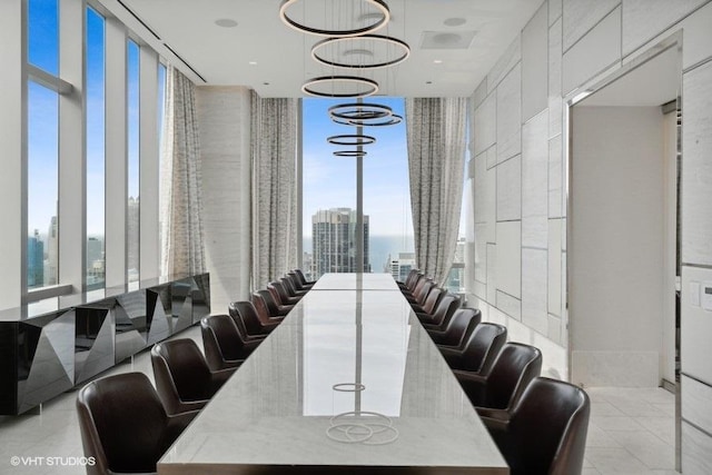 dining space with expansive windows, light tile patterned floors, and a view of city