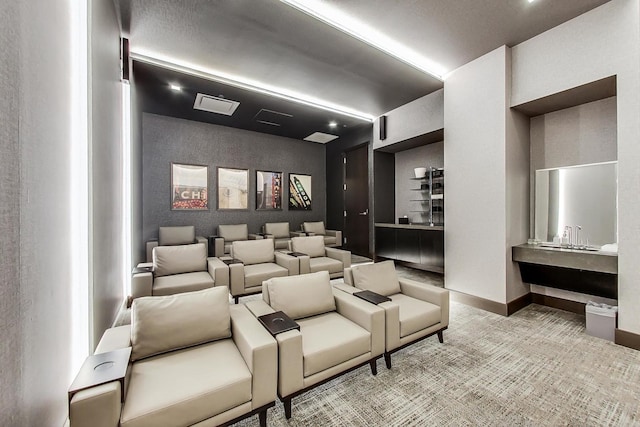 carpeted home theater room with baseboards