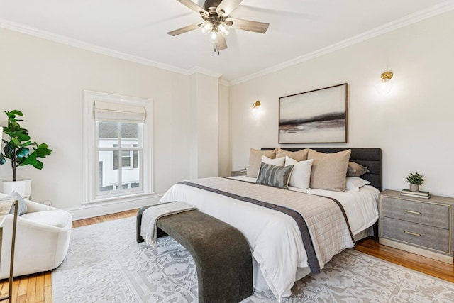 bedroom featuring light wood-type flooring, a ceiling fan, and ornamental molding