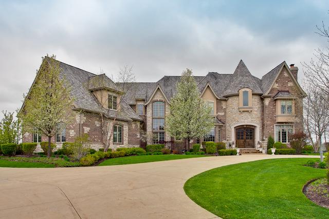 french provincial home with a front yard and a chimney