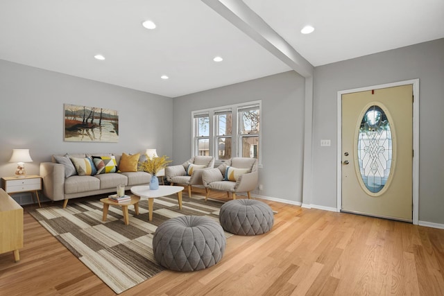 living room with light wood-style floors, baseboards, and recessed lighting