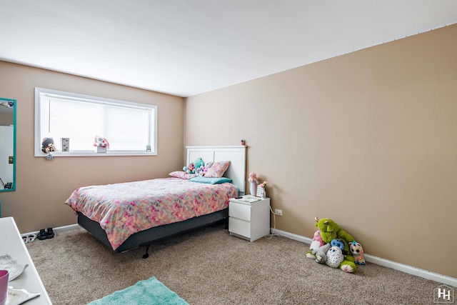 carpeted bedroom featuring baseboards