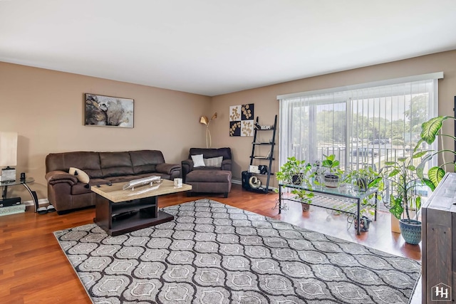 living area featuring baseboards and wood finished floors