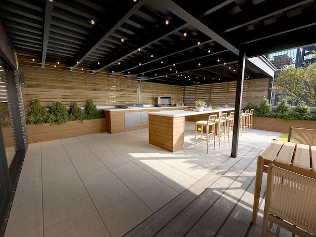 exterior space with exterior kitchen, fence, and outdoor wet bar