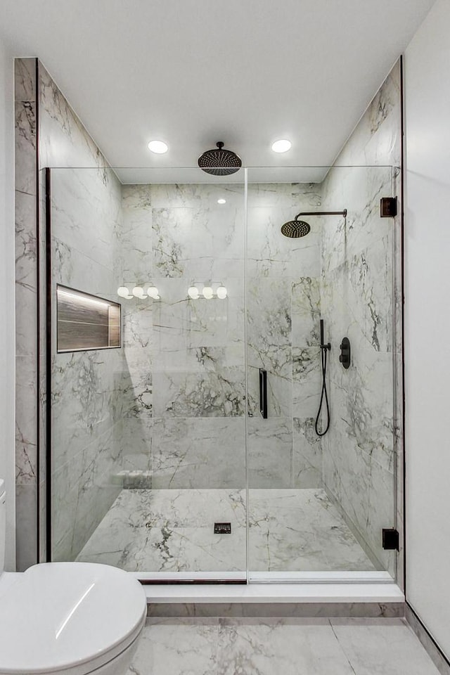 full bath with marble finish floor, a marble finish shower, and toilet