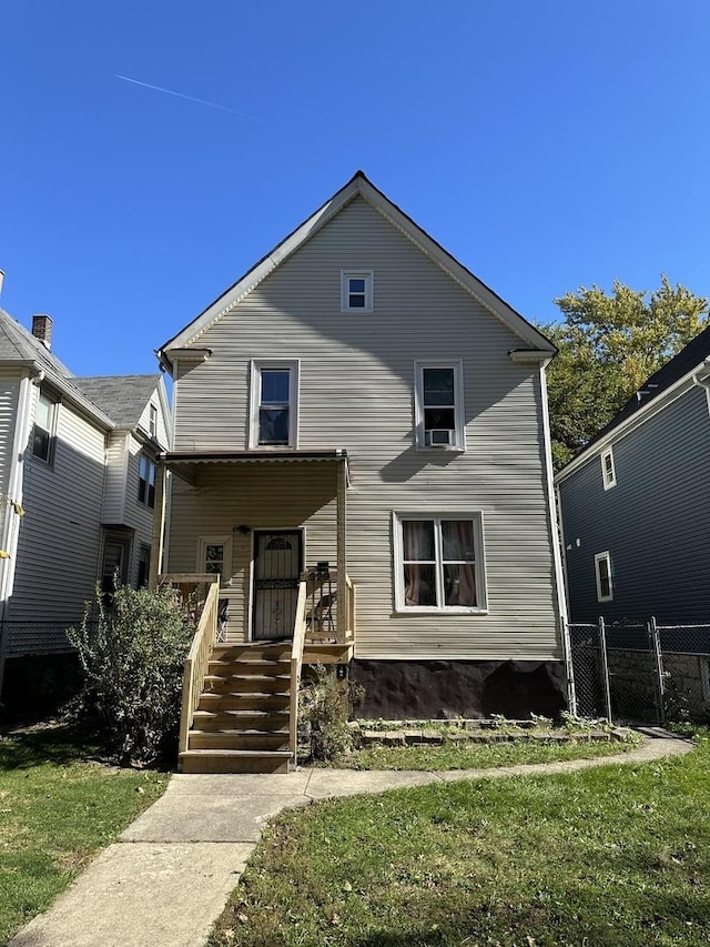 view of front of house featuring covered porch, a gate, and a front lawn