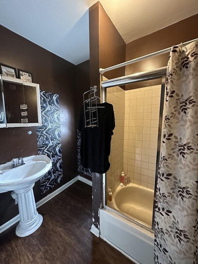 full bath featuring shower / tub combo with curtain, baseboards, and wood finished floors