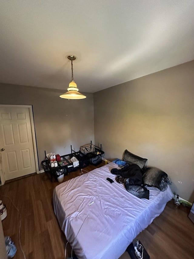 bedroom featuring wood finished floors and baseboards