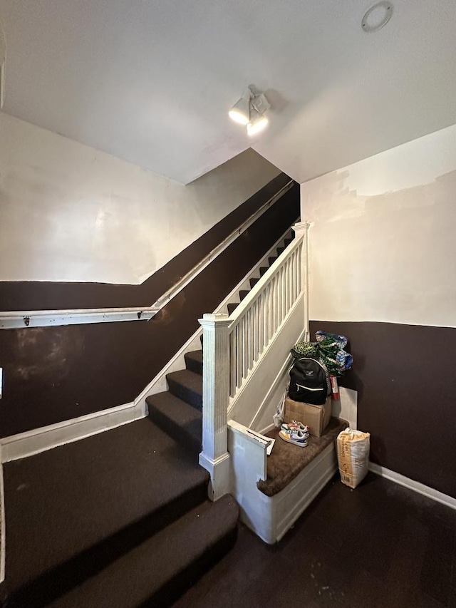 staircase featuring baseboards