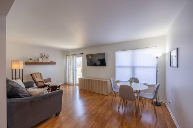 living room featuring light wood-style flooring and baseboards