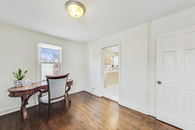 home office with baseboards and wood finished floors