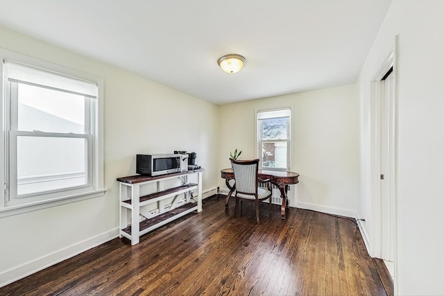 home office featuring baseboards and wood finished floors