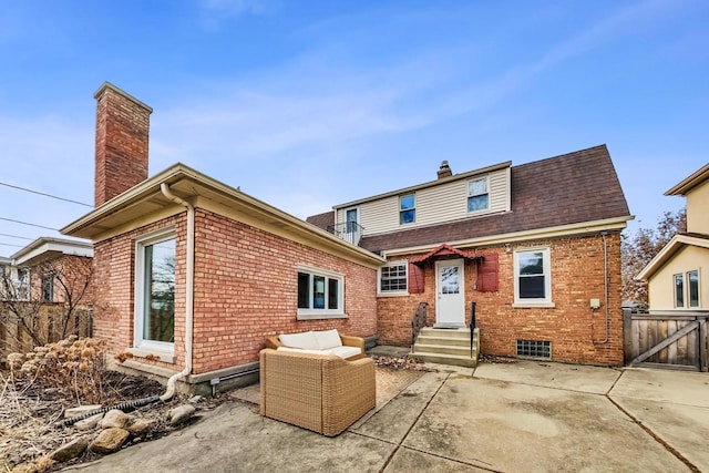 rear view of property with brick siding, a chimney, and entry steps