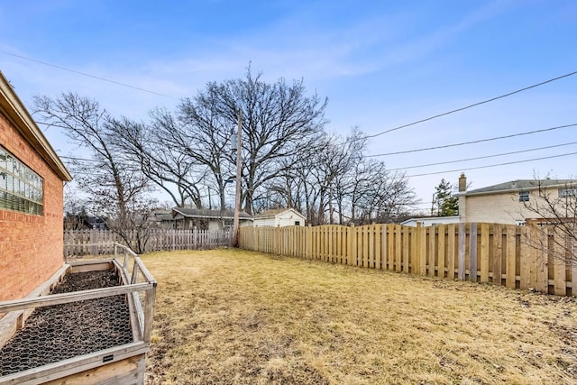 view of yard with a fenced backyard and a vegetable garden