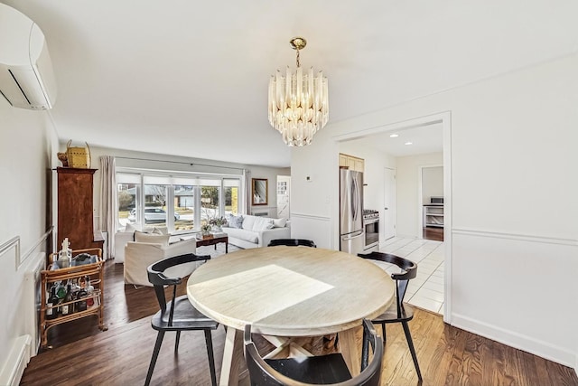 dining room featuring recessed lighting, a notable chandelier, an AC wall unit, and wood finished floors