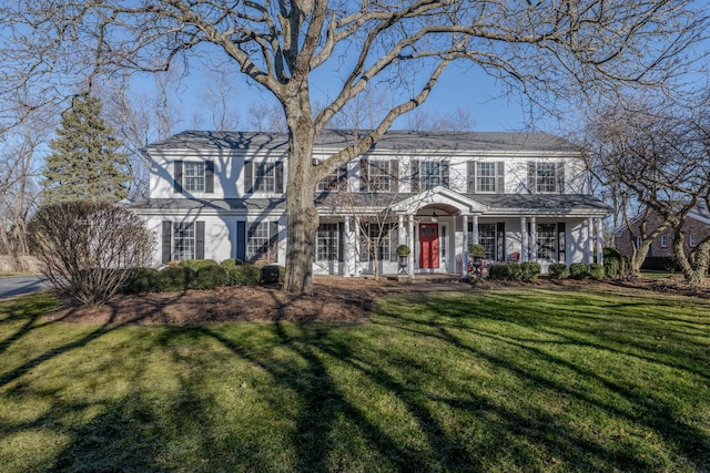 view of front facade with covered porch and a front lawn