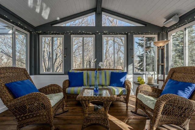 sunroom featuring lofted ceiling with beams and a healthy amount of sunlight