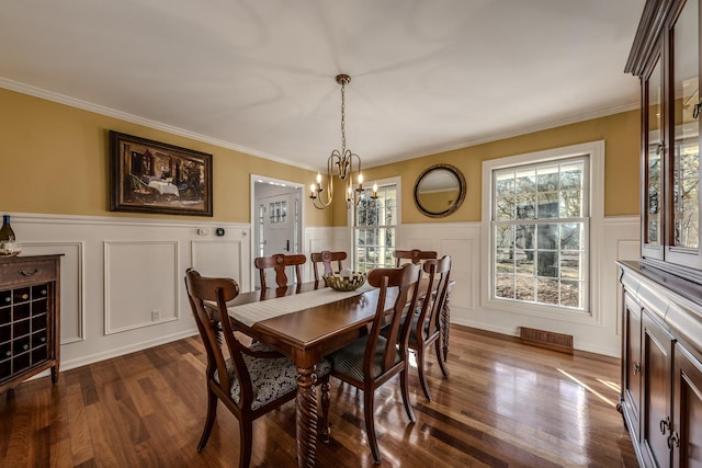 dining area with visible vents, an inviting chandelier, dark wood-style floors, and a healthy amount of sunlight