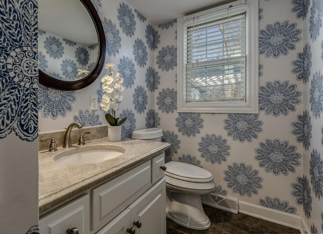 bathroom featuring visible vents, toilet, tile patterned flooring, baseboards, and vanity