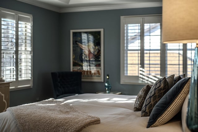 bedroom with multiple windows and ornamental molding