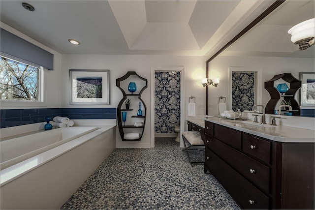 bathroom featuring vanity, a garden tub, and recessed lighting