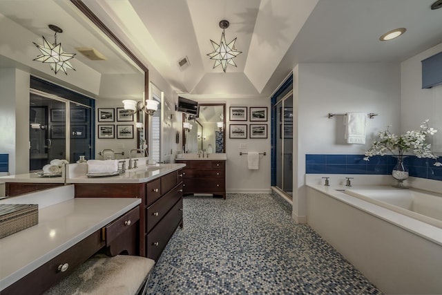 full bath featuring visible vents, lofted ceiling, a sink, a shower stall, and a garden tub