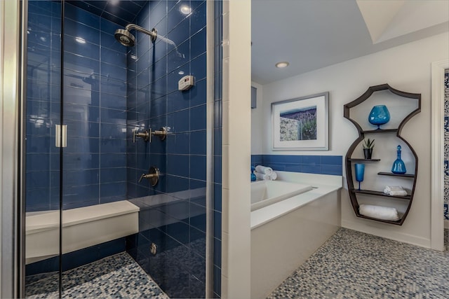 bathroom featuring a bath and a stall shower