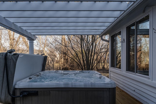 wooden deck with a pergola and a hot tub