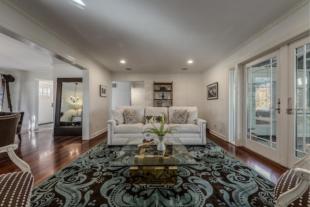 living area featuring baseboards, ornamental molding, recessed lighting, an inviting chandelier, and wood finished floors