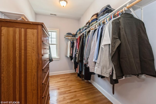 walk in closet featuring light wood finished floors and visible vents