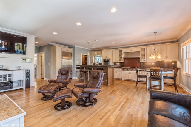 living room featuring crown molding, light wood-style flooring, and baseboards